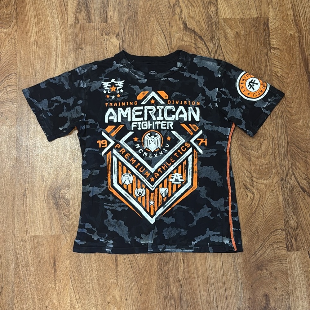 American Fighter Kids Camo Graphic Tee - Black and Orange. Youth Large.